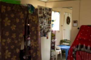 The big cloth thing on the left is our closet and the rid to the right is our home-school supplies. The door is our prayer wall (can you find your picture?)