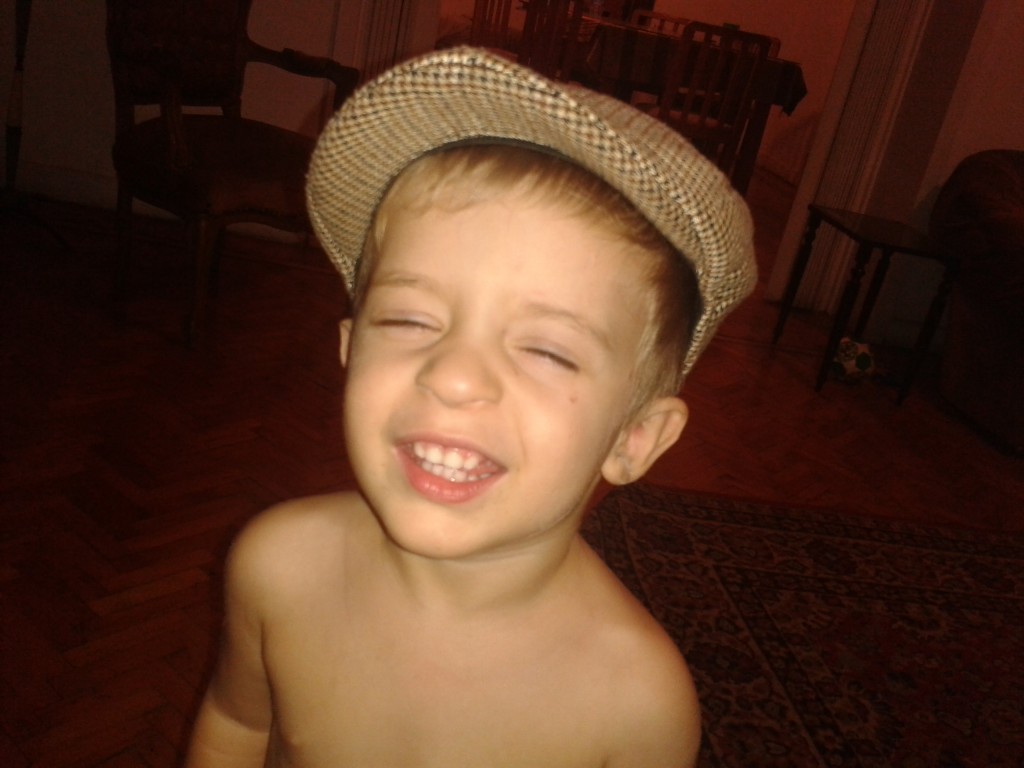 12- a little boy who loves hats, and saying cheese...