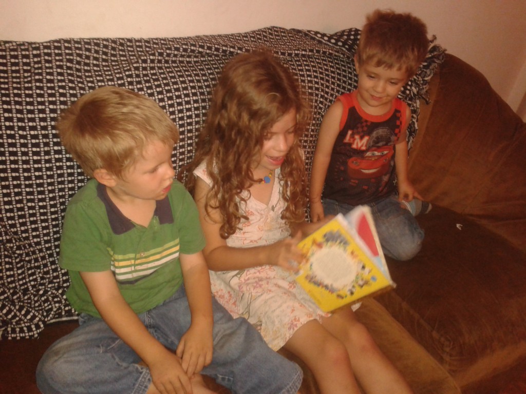 07-the girls reading to the boys on the couch