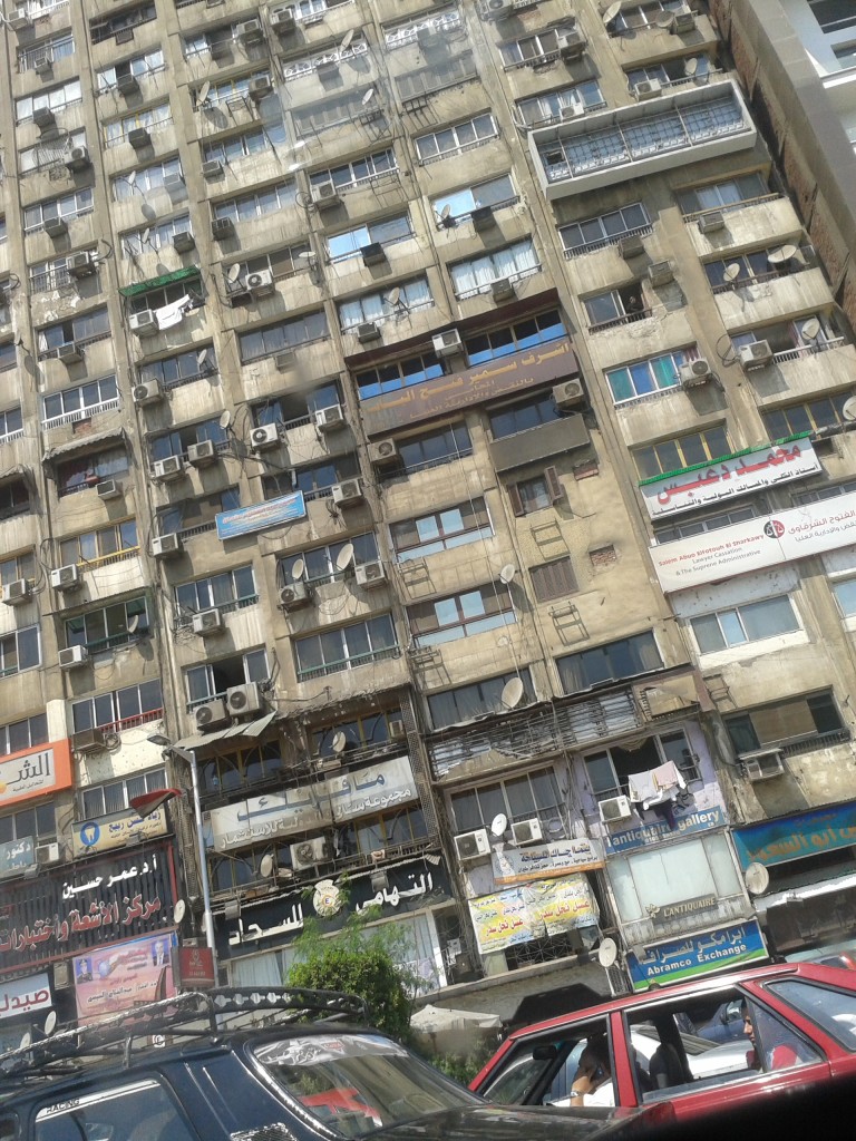 1:10pm- gridlock traffic in the heat of the day. The view from the road as we sit in the taxi cab.