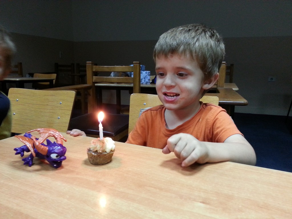 We got Daniel's favorite quick dinner (McDonalds) and a mini cupcake and we sang to him that evening at Dad's work where we set up a movie while we taught a seminar.