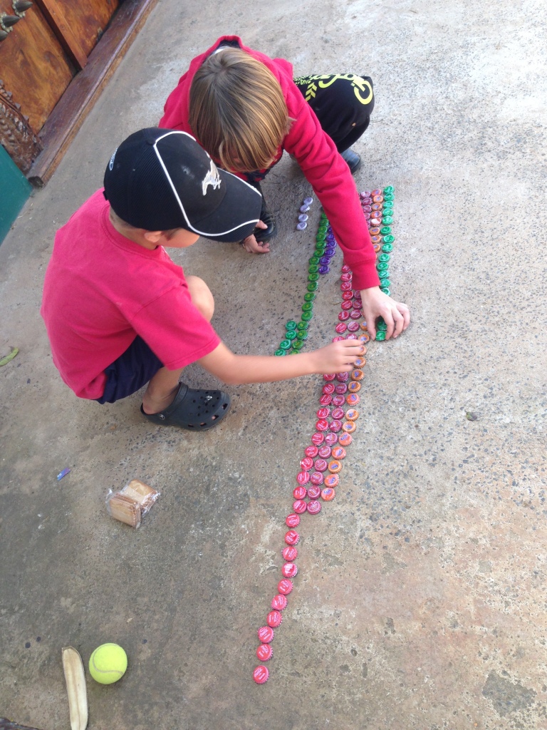 The kids gathered bottle tops all week then lined then up to see what hte winning Soda was...For those that are curious it was Coke followed by Stoney...